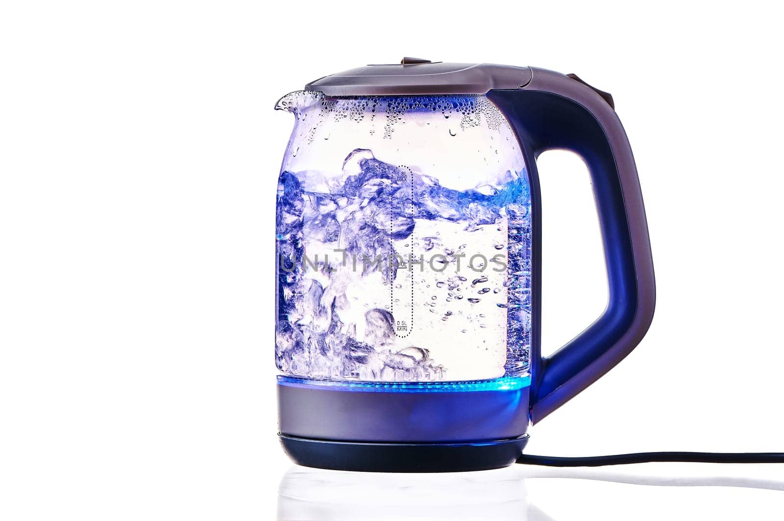 Glass electric kettle with boiling water on a white insulated background. High quality photo