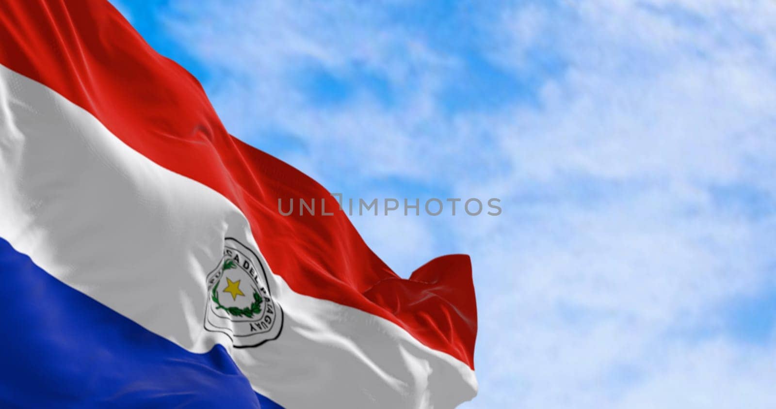 Close up of Paraguay flag waving. Three equal horizontal bands of red, white and blue with an emblem centered in the white band. 3d illustration render. Selective focus. Fluttering fabric. Patriotism