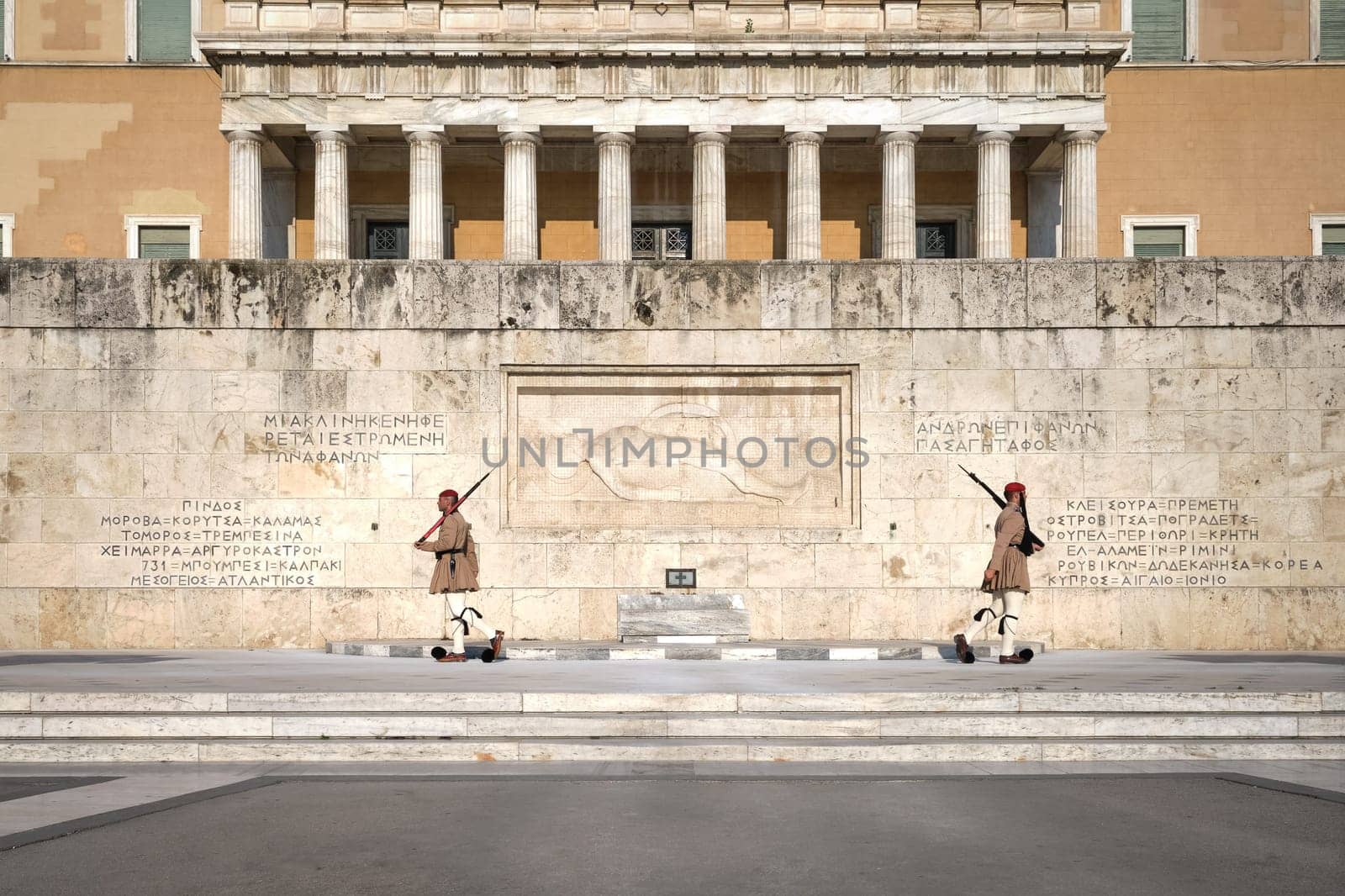 Ceremony of Presidential guard Evzones by the Greek tomb of Unknown Soldier. Evzones in summer uniform separate. Wide shot.