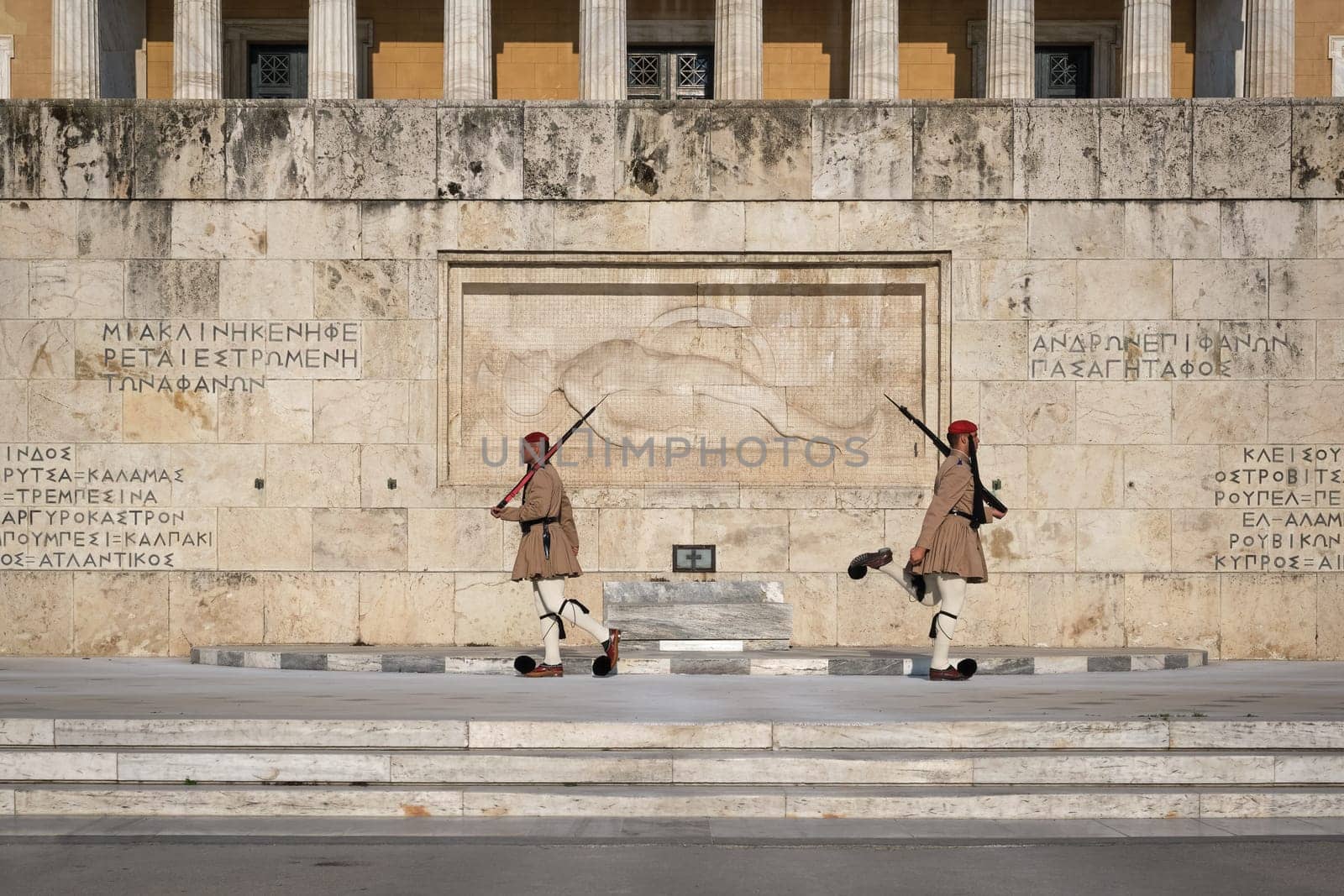 Ceremony of Presidential guard Evzones by the Greek tomb of Unknown Soldier. Evzones in summer uniform separate . Wide shot.