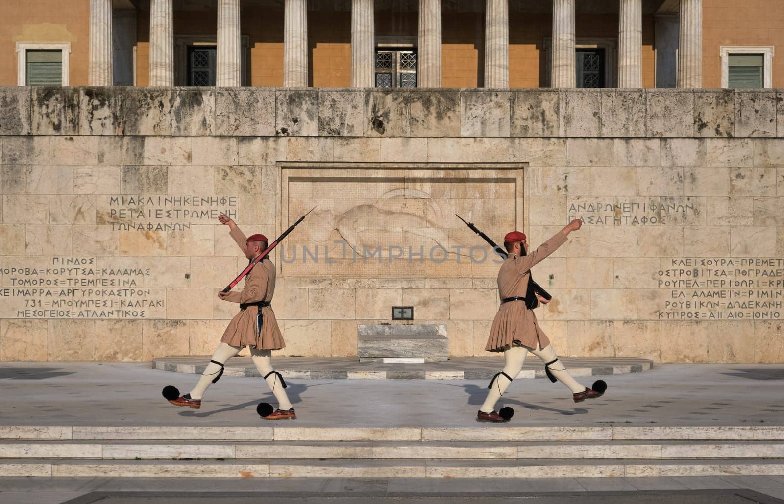 Ceremony of Presidential guard Evzones by the Greek tomb of Unknown Soldier. Evzones in summer uniform separate, march away Wide shot.