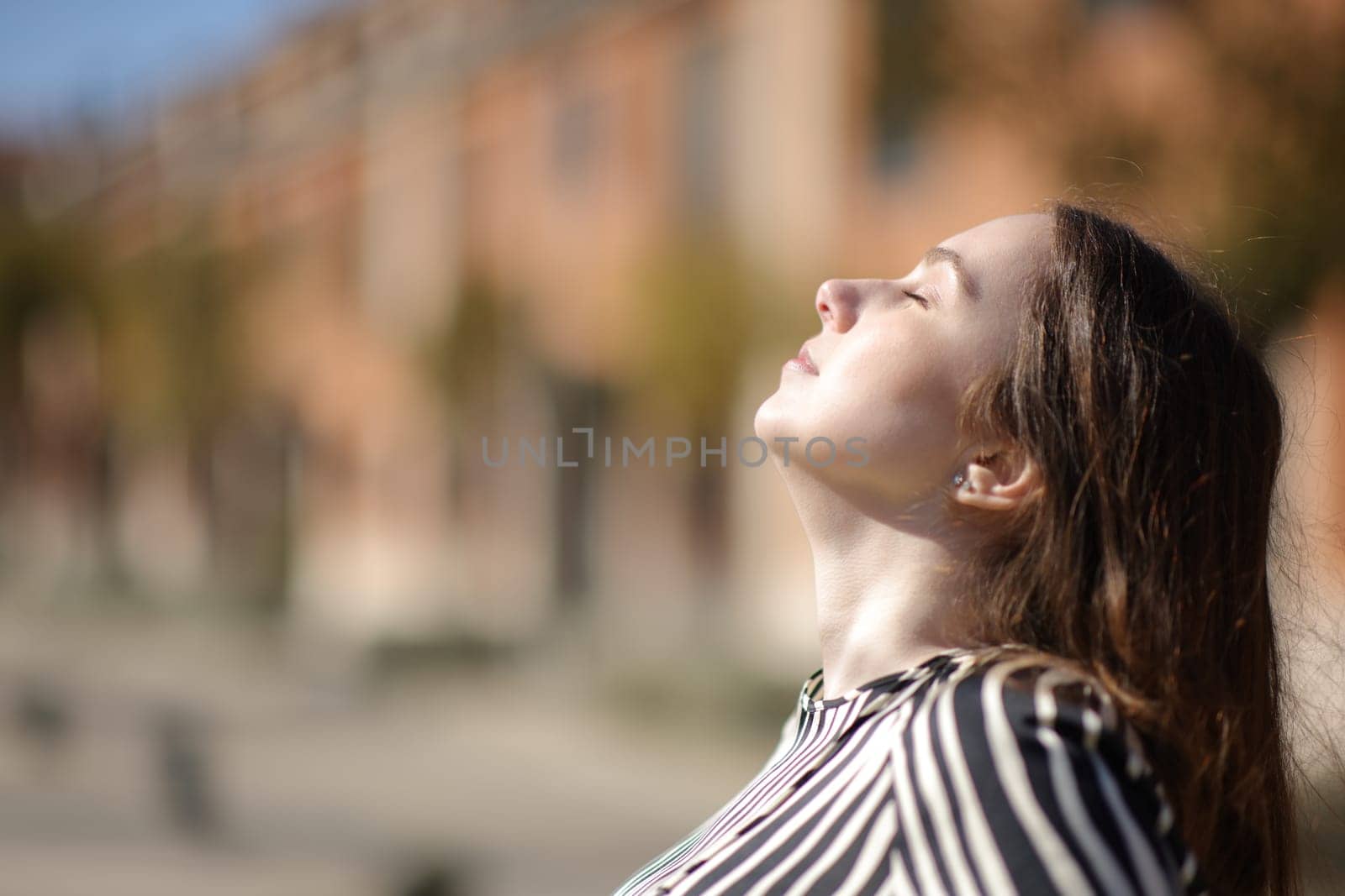 Side view portrait of an elegant woman breathing frens air in a residential area