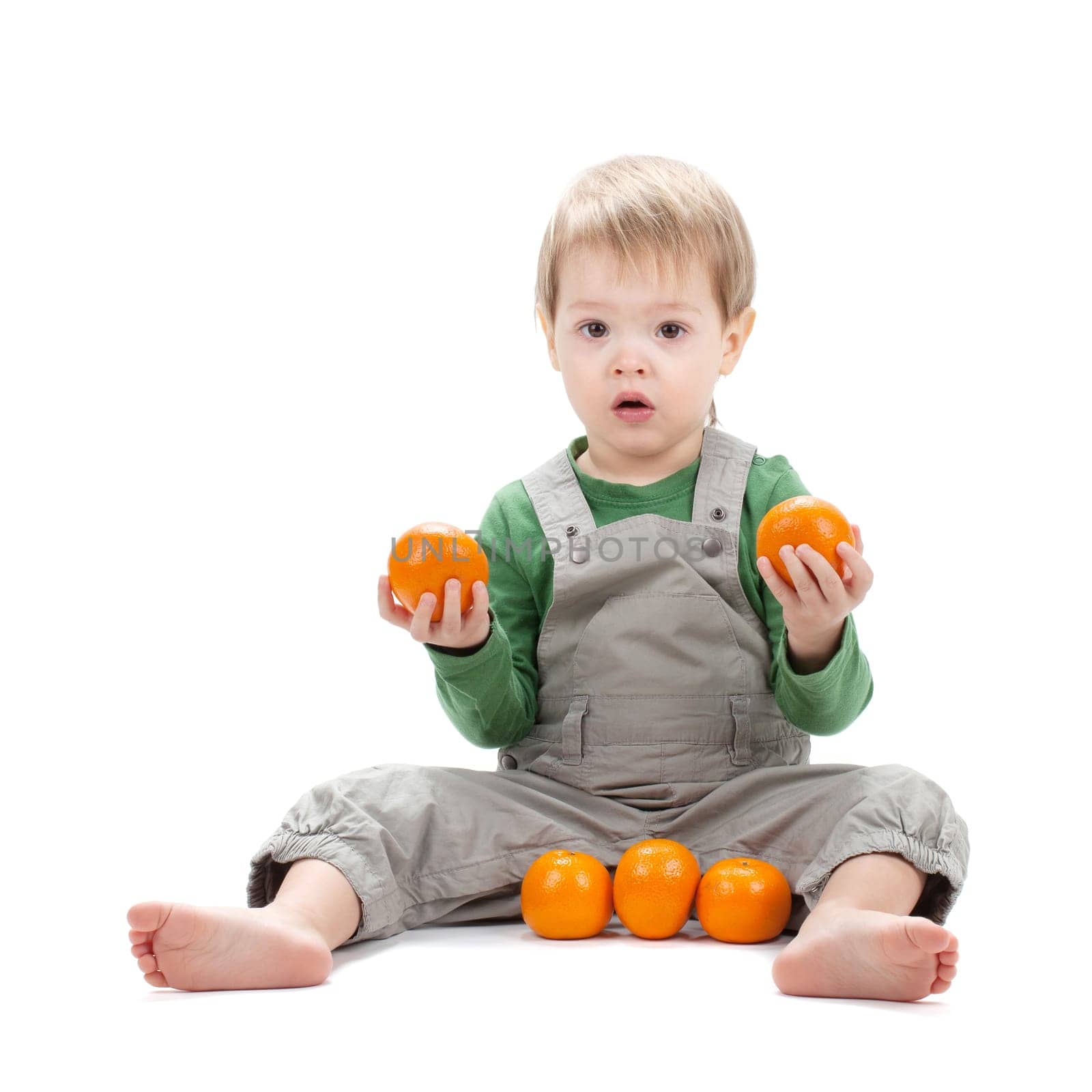 Baby with oranges. Isolated on white background