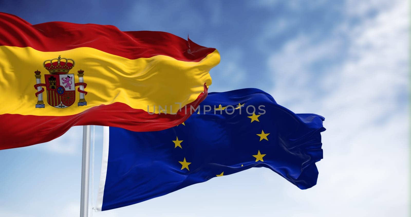 the flags of Spain and the European Union waving in the wind on a sunny day. Democracy and politics. European Union member state. 3d illustration render. Fluttering fabric