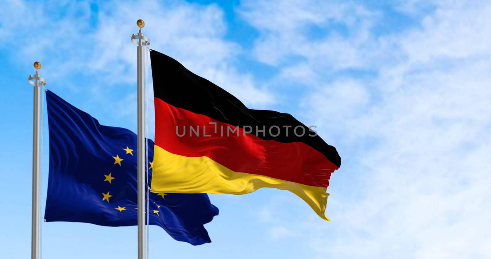 The flags of Germany and the European Union waving in the wind on a clear day. Germany became a member of the EU in january 1958. 3d illustration render. Fluttering fabric. Selective focus