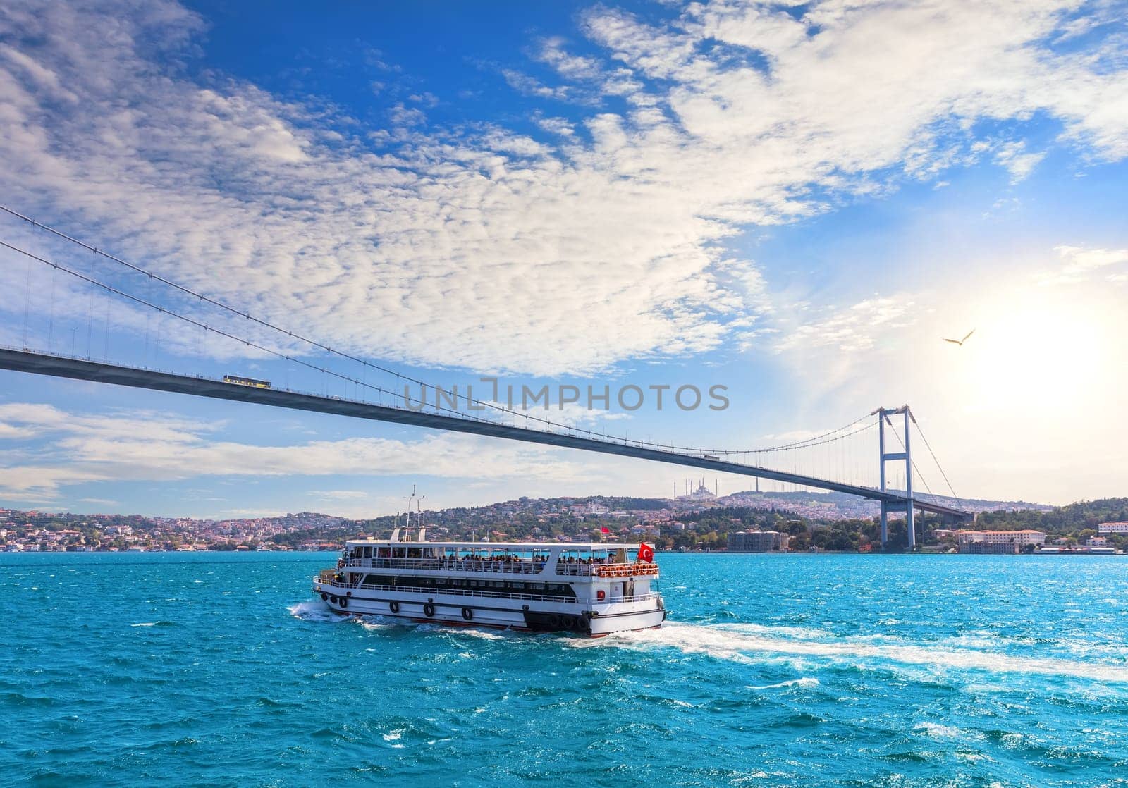 Ship is sailing near the Bosphorus bridge and modern Istanbul view, Turkey.