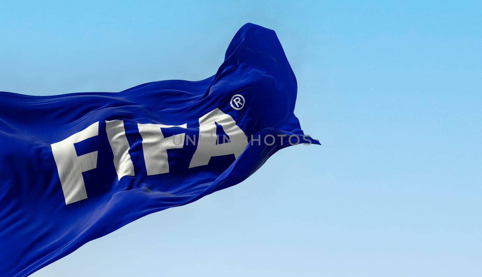 Zurich, CH, June 25 2023: Fifa flag waving in the wind on a clear day. International governing body of association football, beach football and futsal. Illustrative editorial 3D illustration render