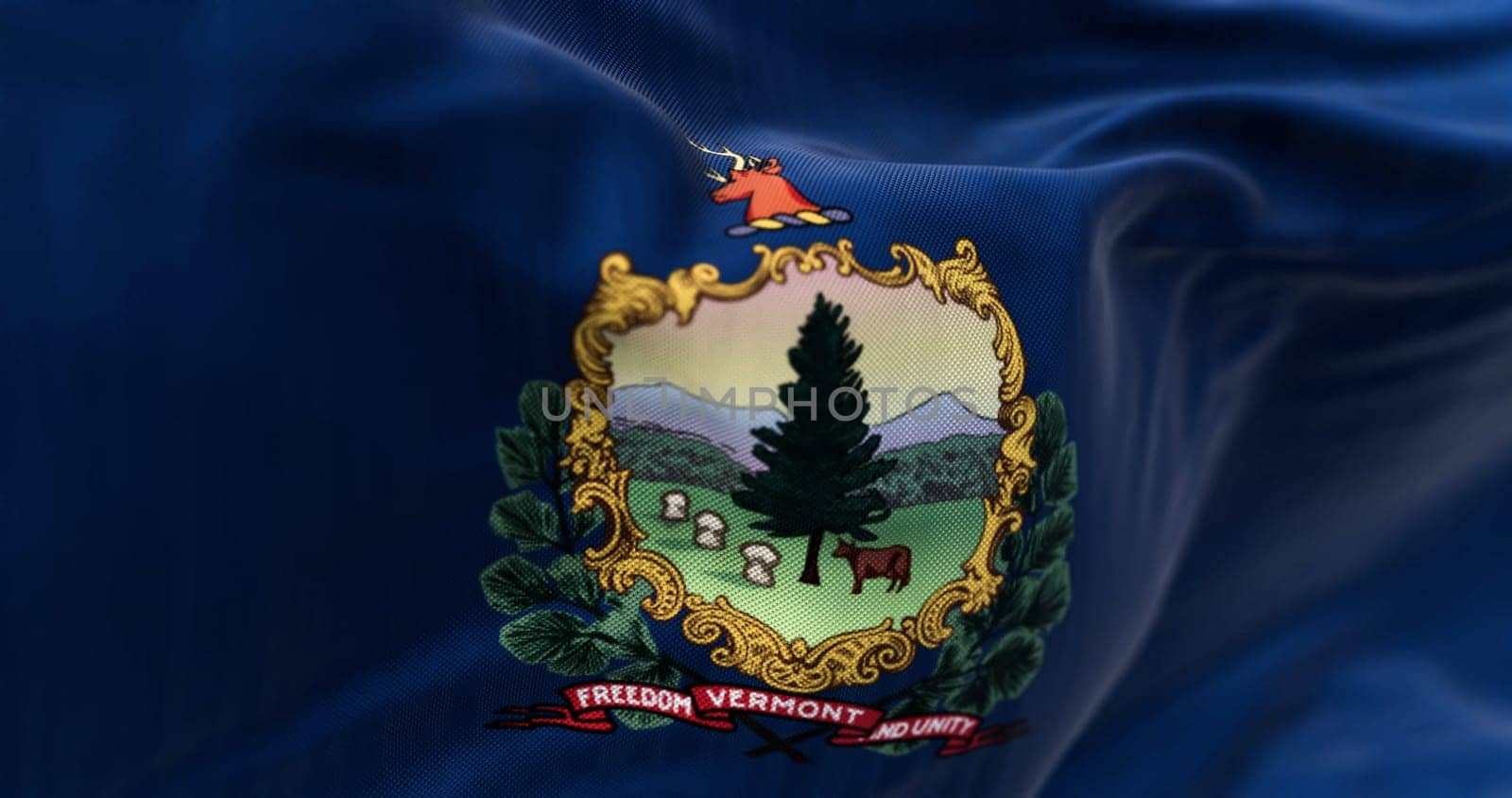 Close-up of the Vermont state flag waving in the wind. Blue background with State coat of arms and motto. 3d illustration render. Selective focus. Fluttering fabric.