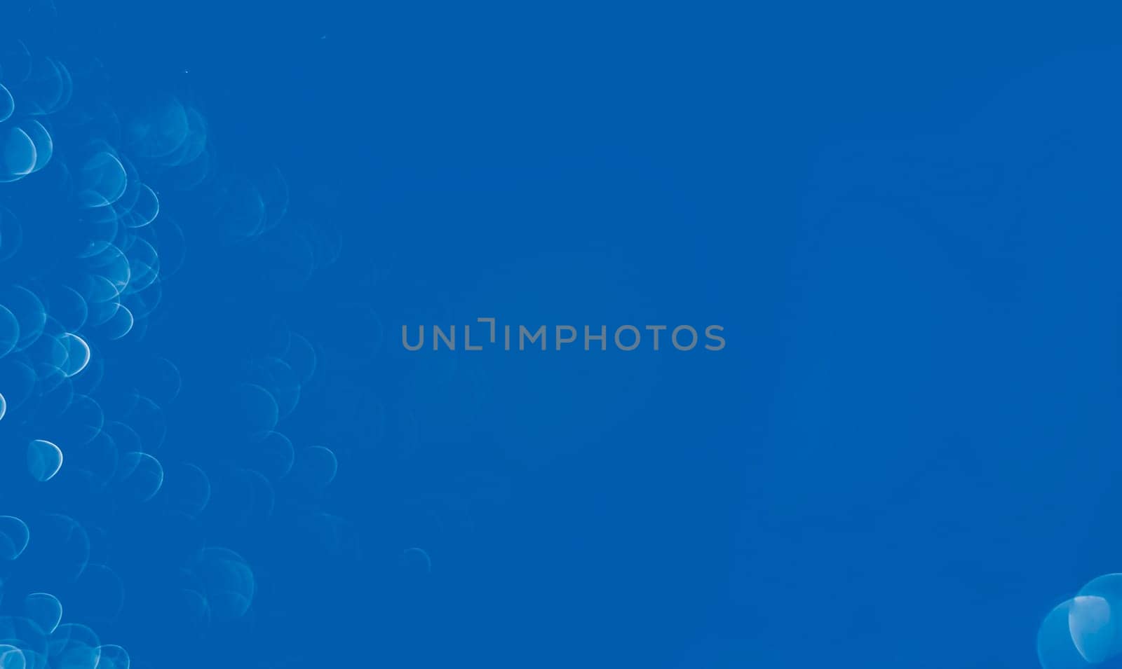 Light abstract blue bokeh christmas circle color glitter blurred black background