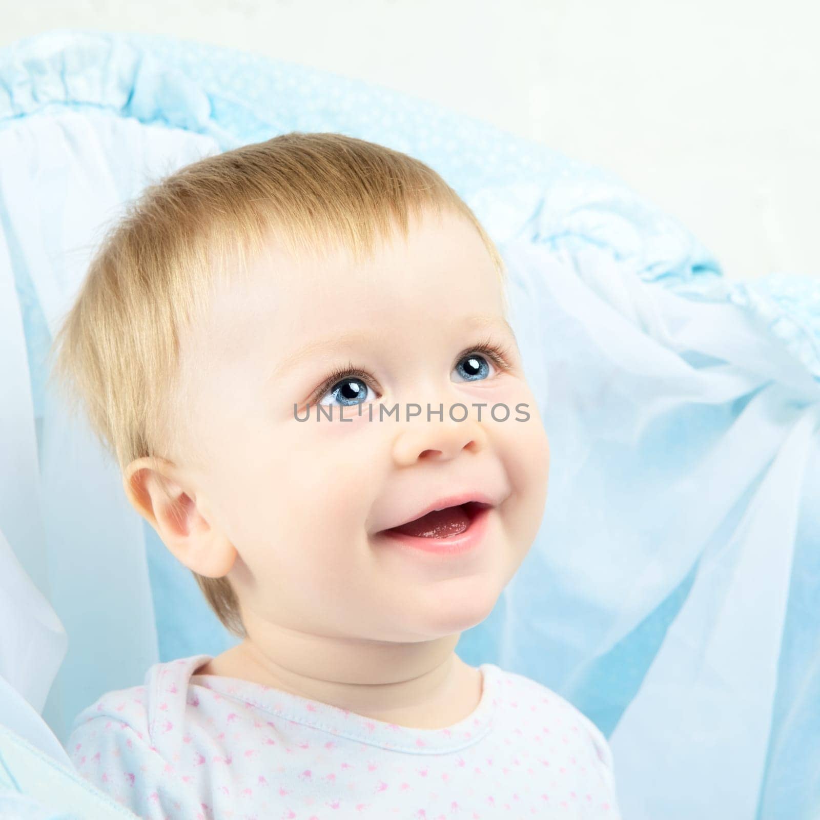 beautiful laughing baby with blue eyes portrait
