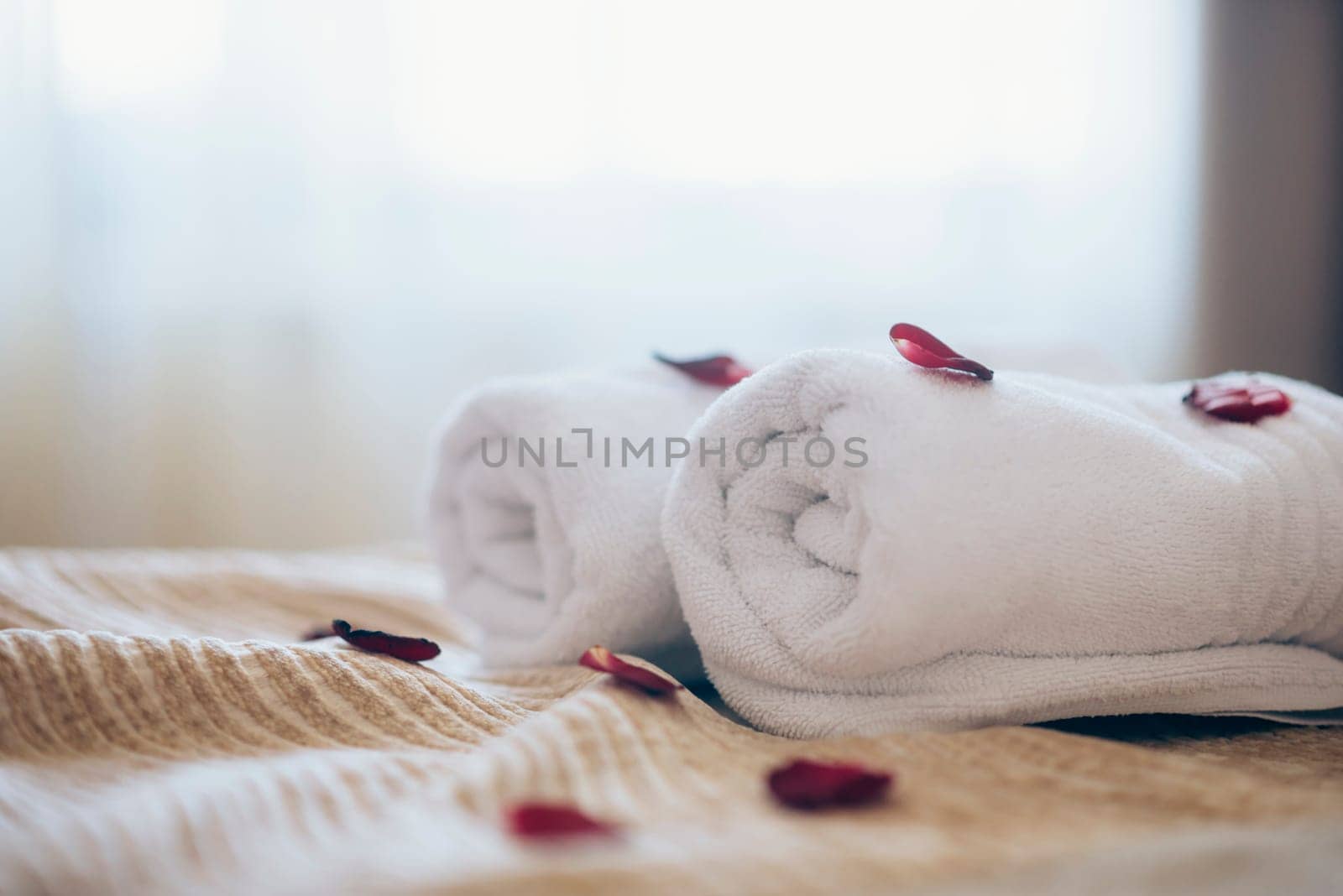 Luxury spa hotel room for romantic weekend. Honeymoon suite bedroom decorated with rose petals.