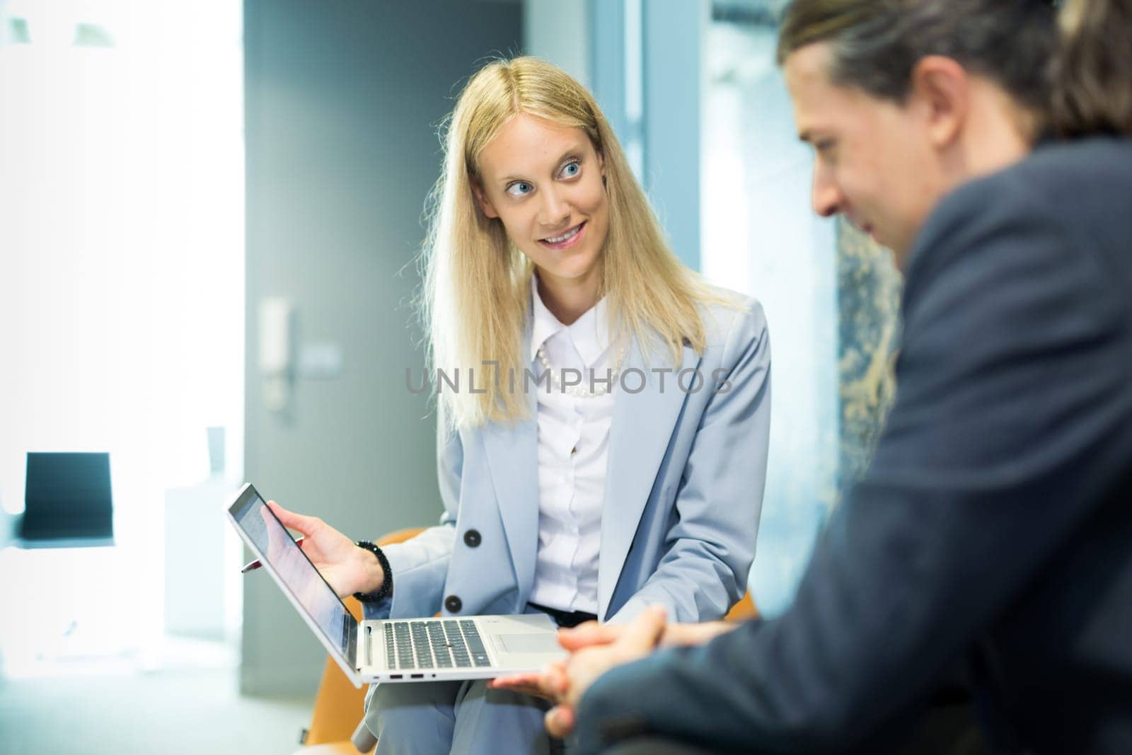 Business meeting. Client consulting. Confident business woman, real estate agent, financial advisor explaining details of project or financial product to client in office