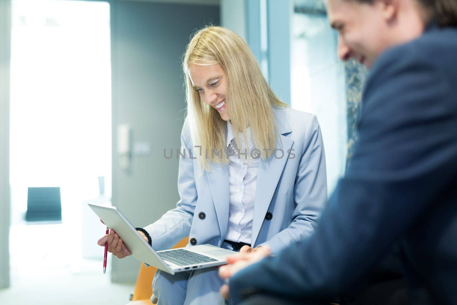 Business meeting. Client consulting. Confident business woman, real estate agent, financial advisor explaining details of project or financial product to client in office