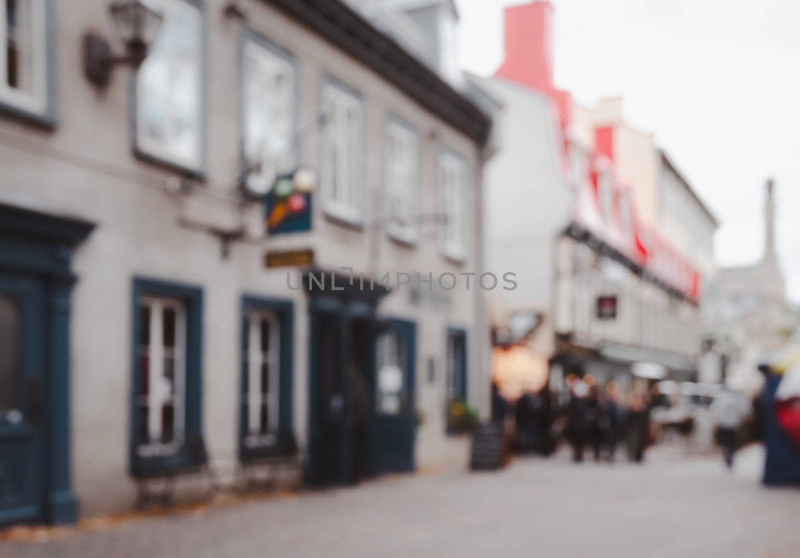 Blurred abstract street view of old town buildings and shopping stores with bokeh lights background
