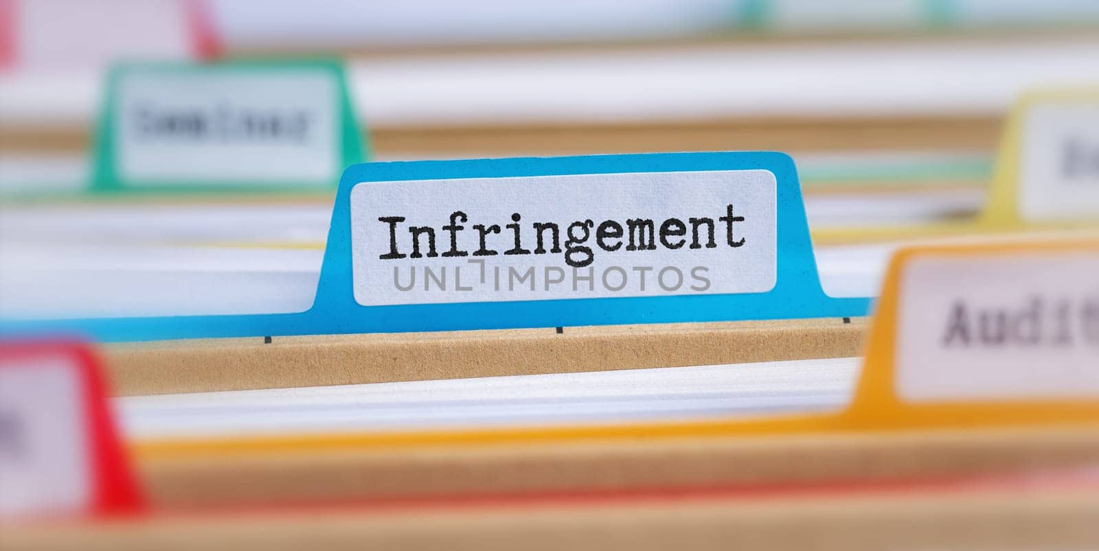 File folders with a tab labeled Infringement