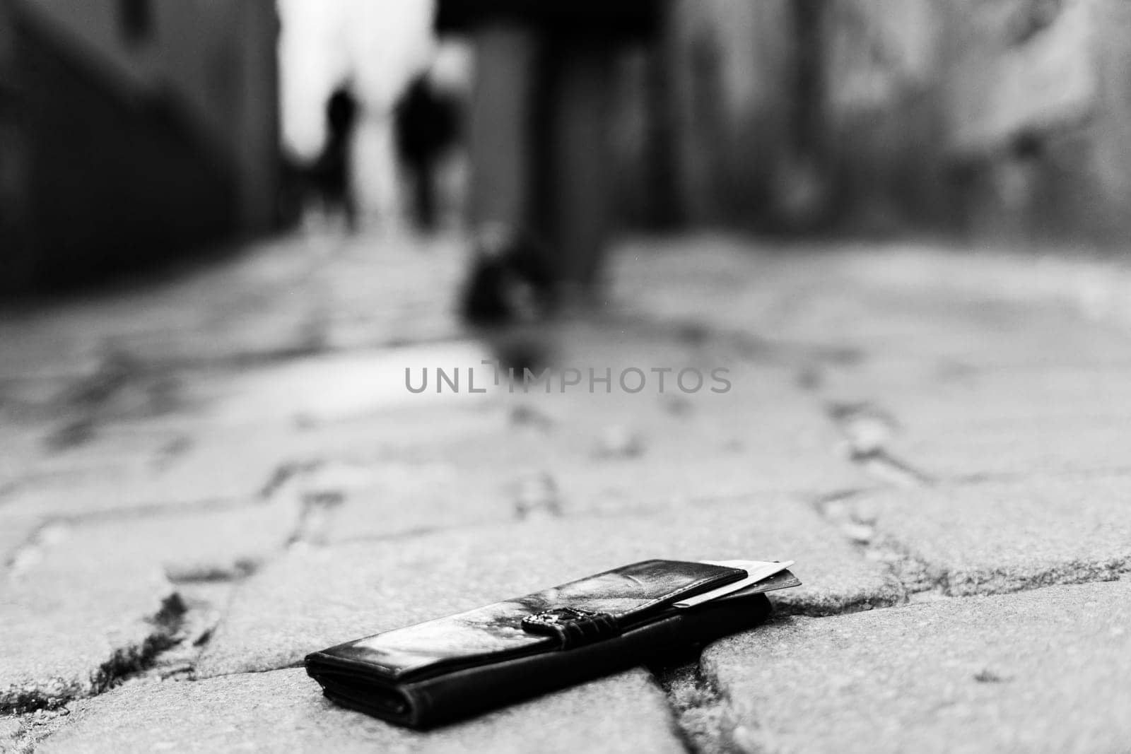 The wallet with coins on a sidewalk street, forgotten money