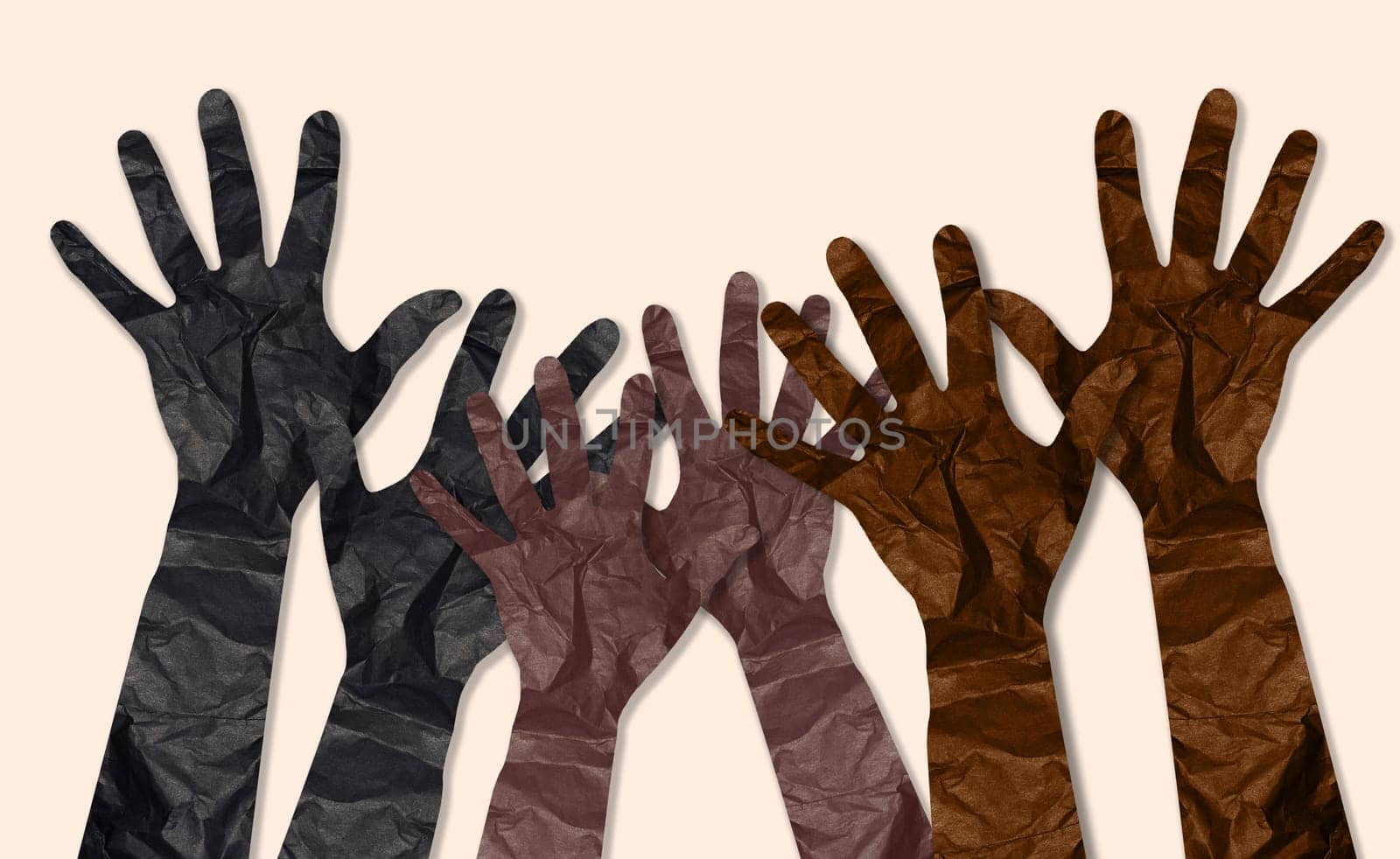 Crumpled paper cut hands raised up on beige background, unification concept