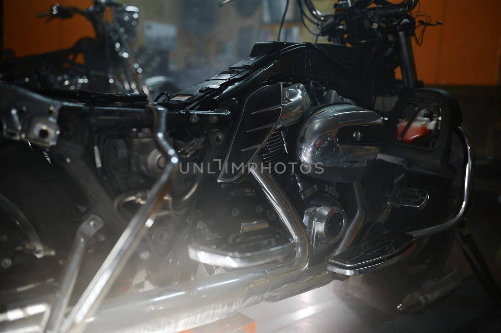 Closeup shot of modern powerful motorbike engine block and chromed exhaust pipes with shiny reflexive surface