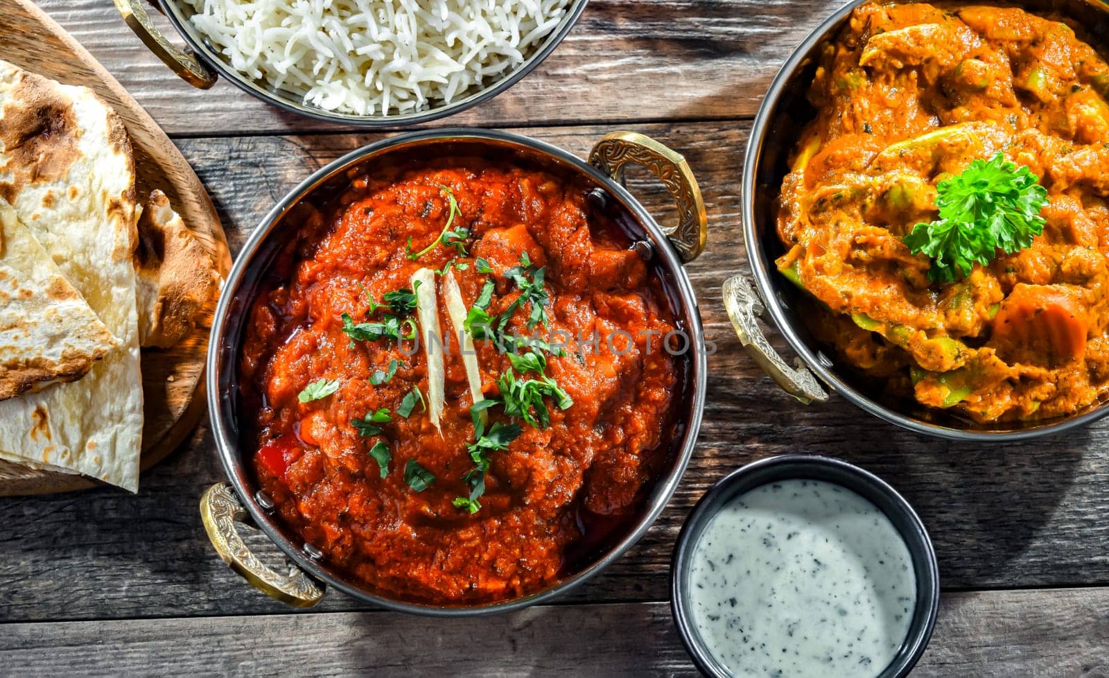 Hot madras paneer and vegetable masala with basmati rice served in original indian karahi pots.