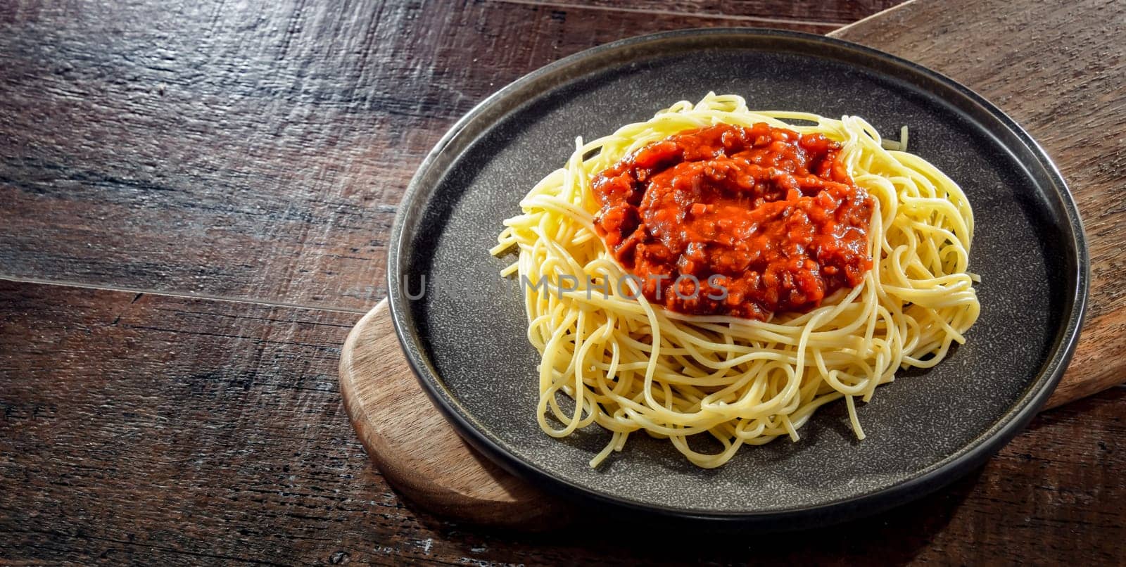 Composition with a plate of spaghetti bolognese.