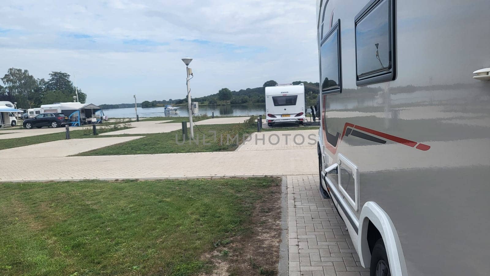 Blitterswijck, The Netherlands - August 22, 2022: Campers parked on a Camer Van pitch. Concept camper van leisure and fun
