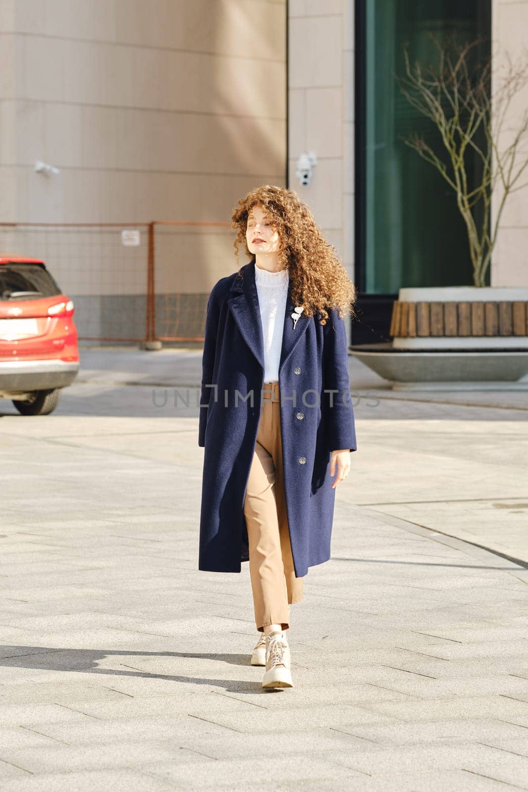 Cute woman walking on the street and looking around