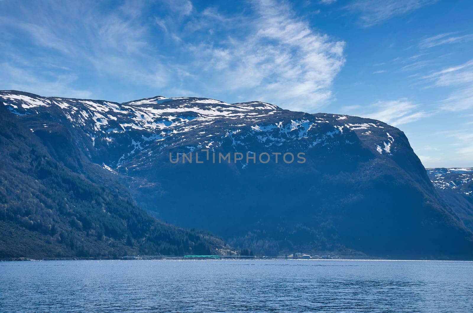 Fjord with view of mountains and fjord landscape in Norway. Landscape shot with sunny blue sky. In the north of Scandinavia