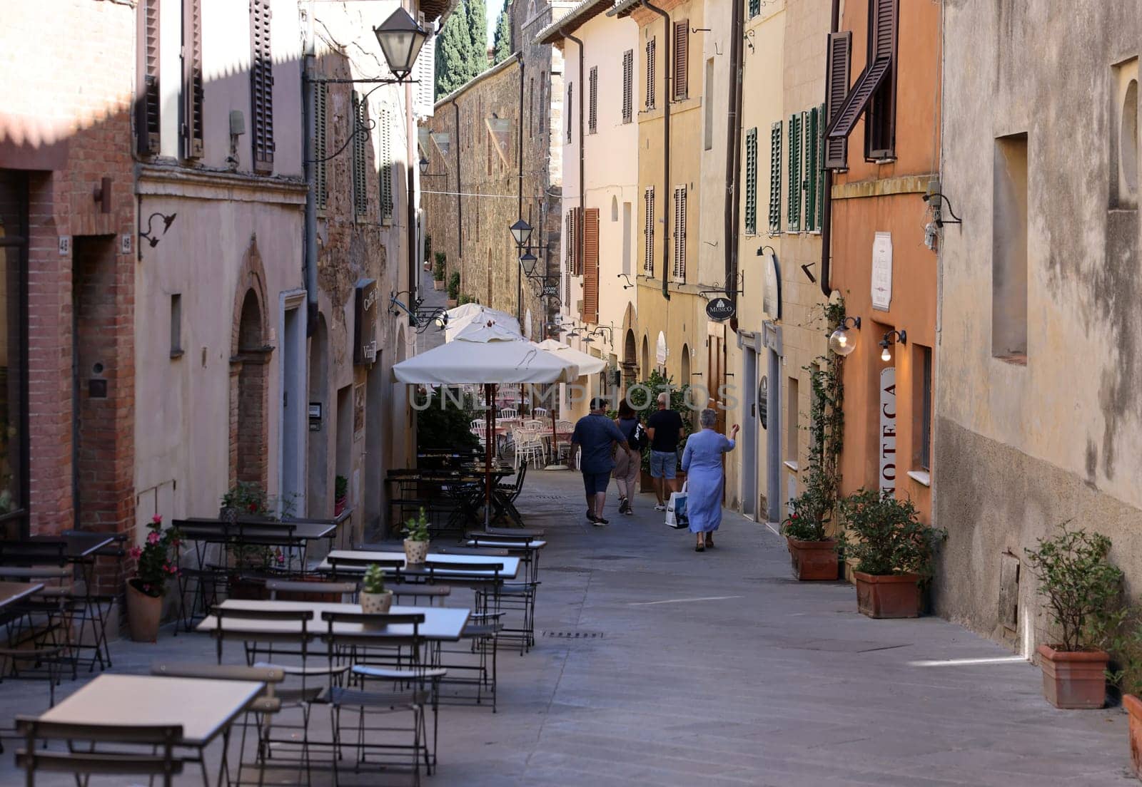 Montalcino, Italy - September 12, 2022: Charming street with bars and wine shops in Montalcino in Tuscany. Italy