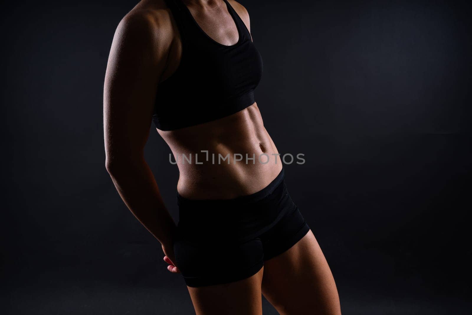 Fitness woman showing abs flat belly, isolated. Athletic female shaped abdominal
