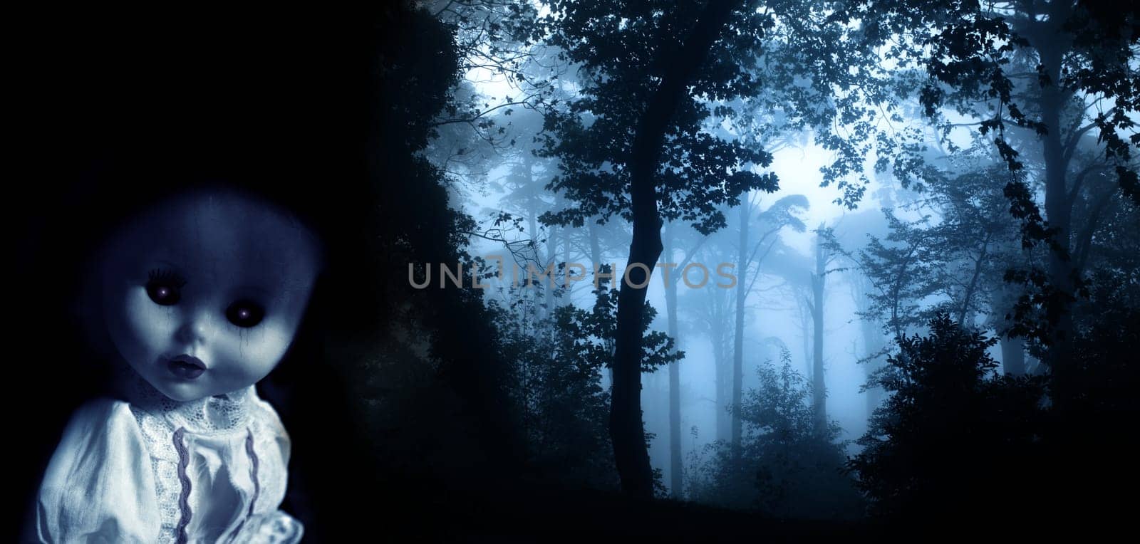 Vintage evil spooky doll and mysterious landscape of foggy forest