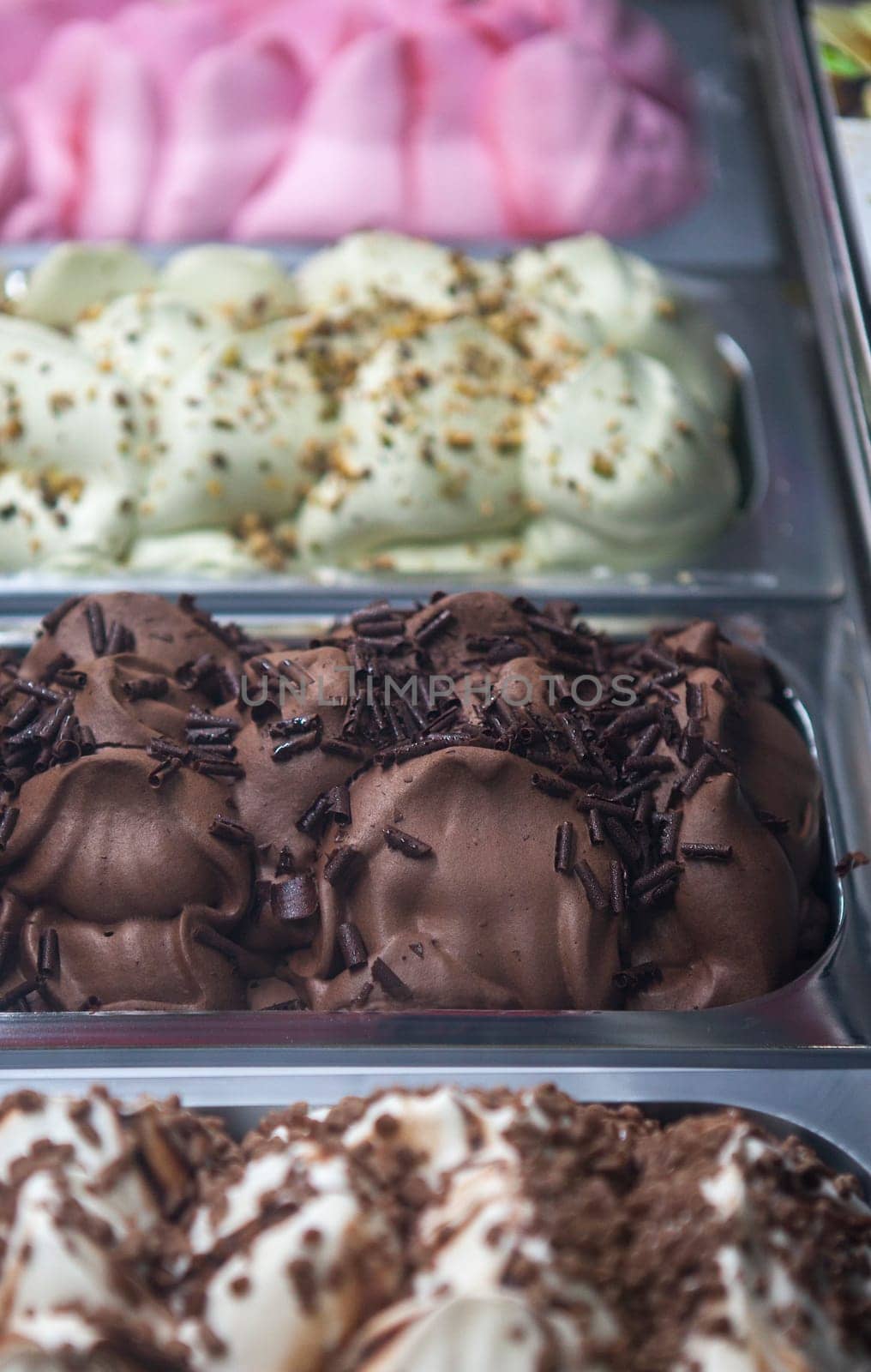 Display counter with assorted ice cream flavours. Selective focus