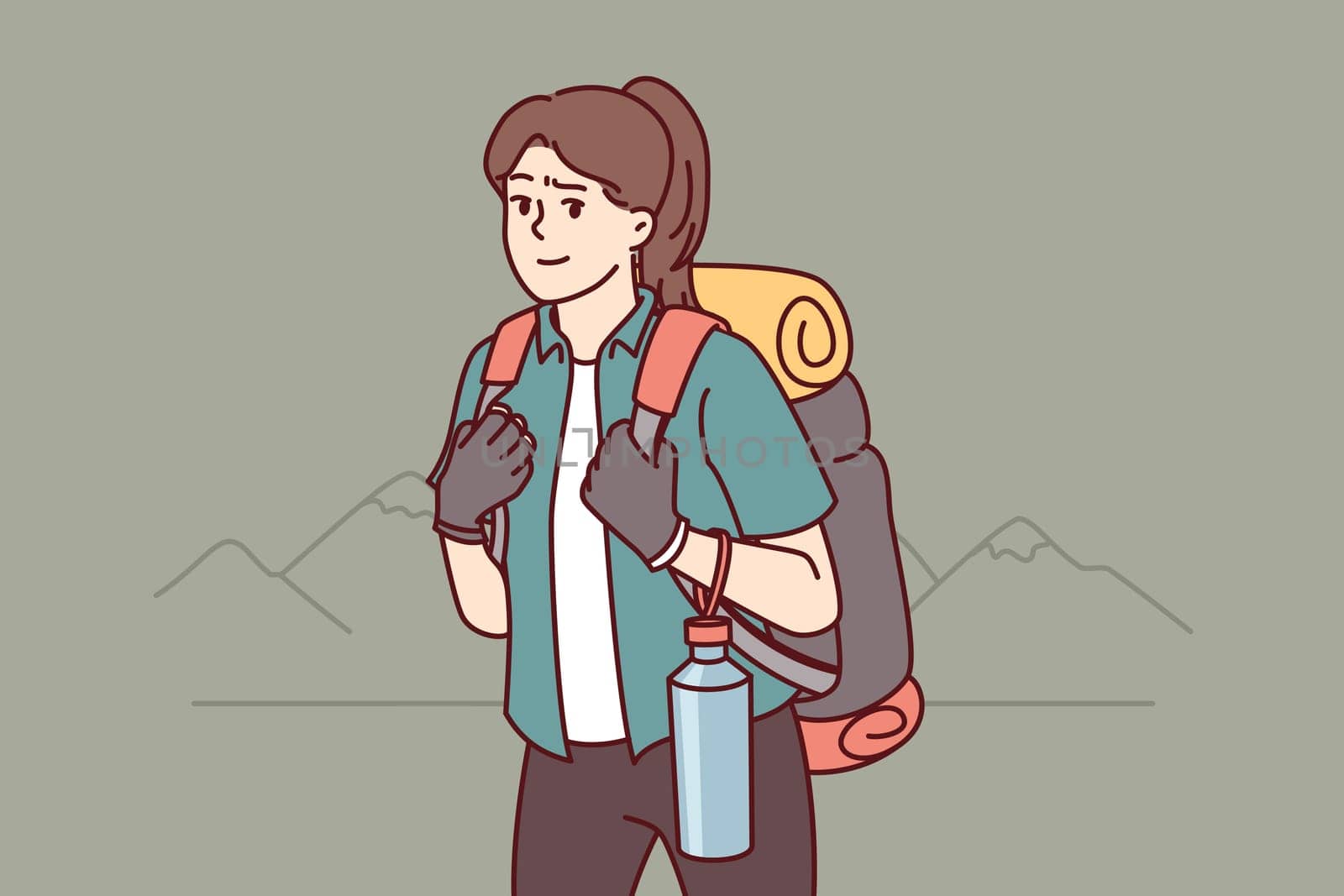 Woman tourist returns from hiking with large backpack on back and bottle of water posing near mountains. Girl is fond of hiking and loves to travel to natural parks and national reserves