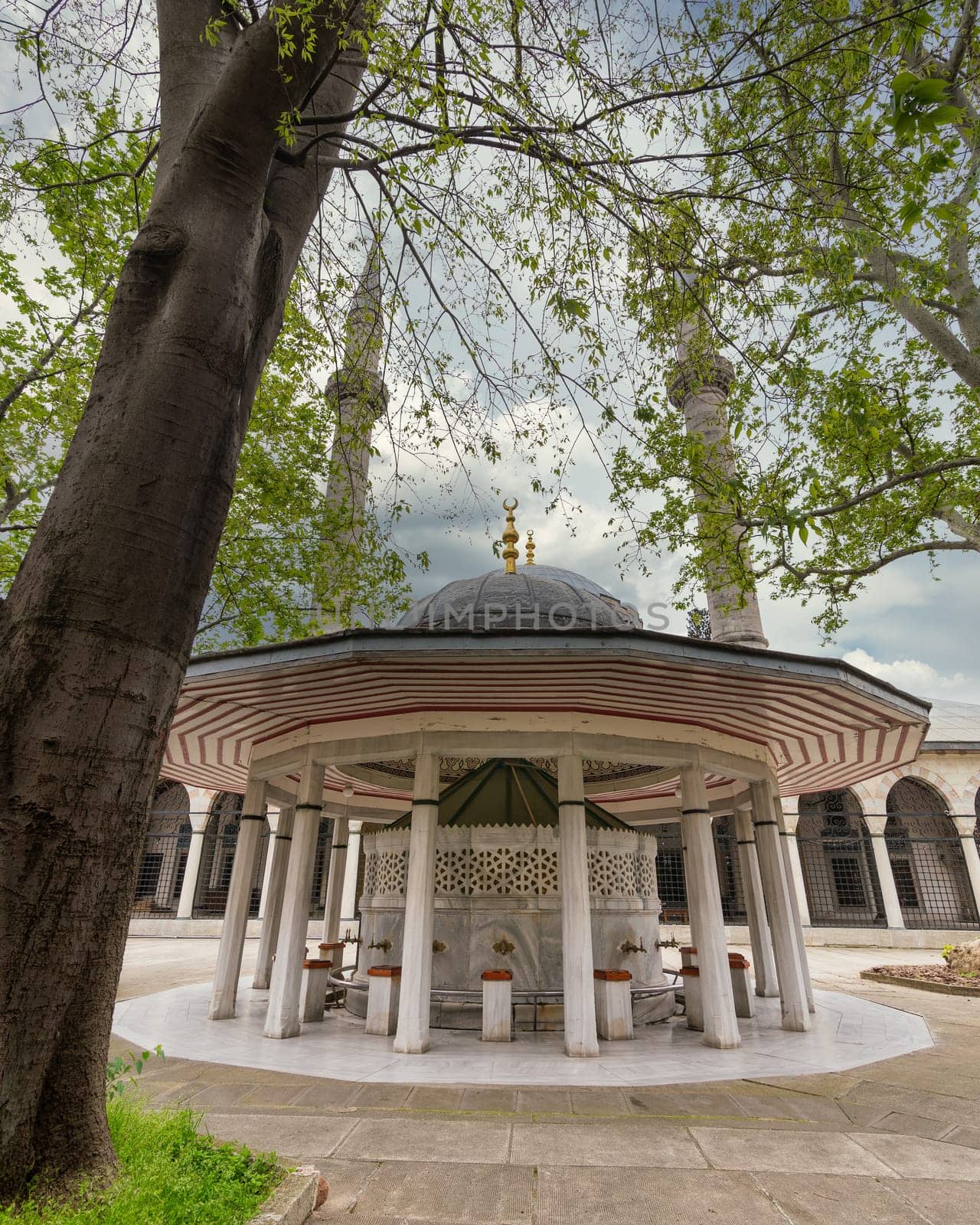 Courtyard of 16th century Atik Valide imperial Ottoman Mosque, with ablution fountain in the front, located in a hill above Uskudar district, in the Asian side of Istanbul, Turkey