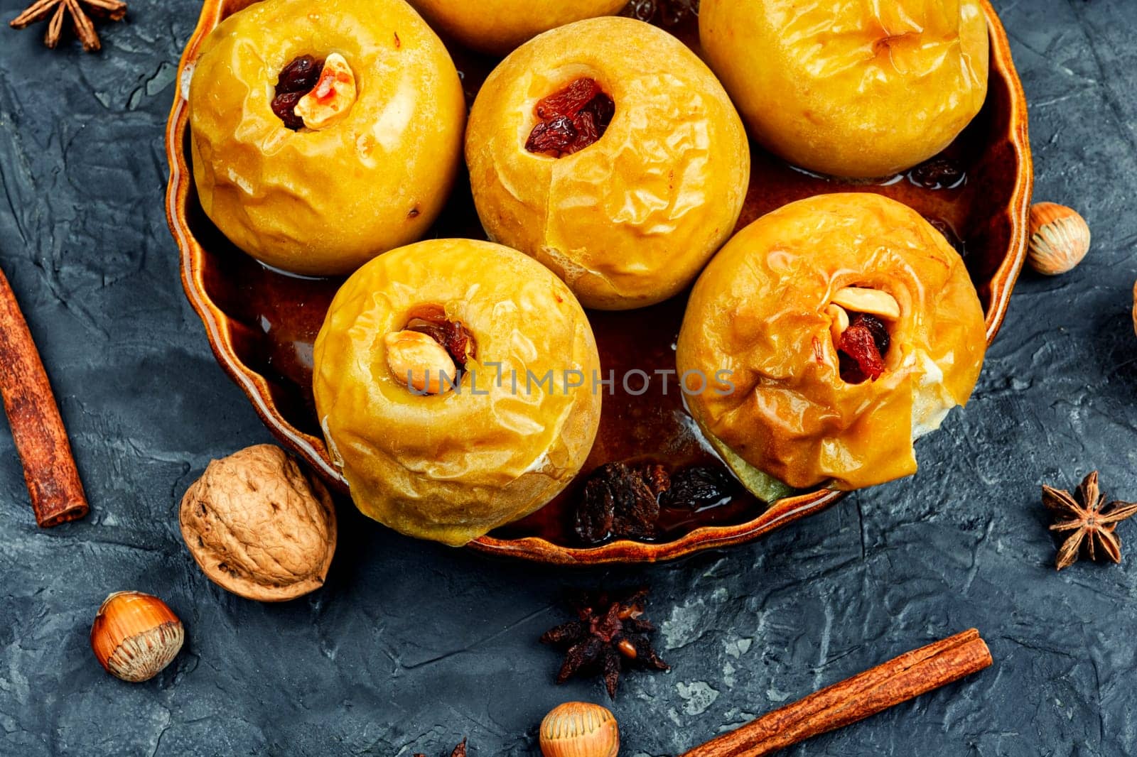 Delicious baked autumn apples with nuts and raisins. Healthy diet.
