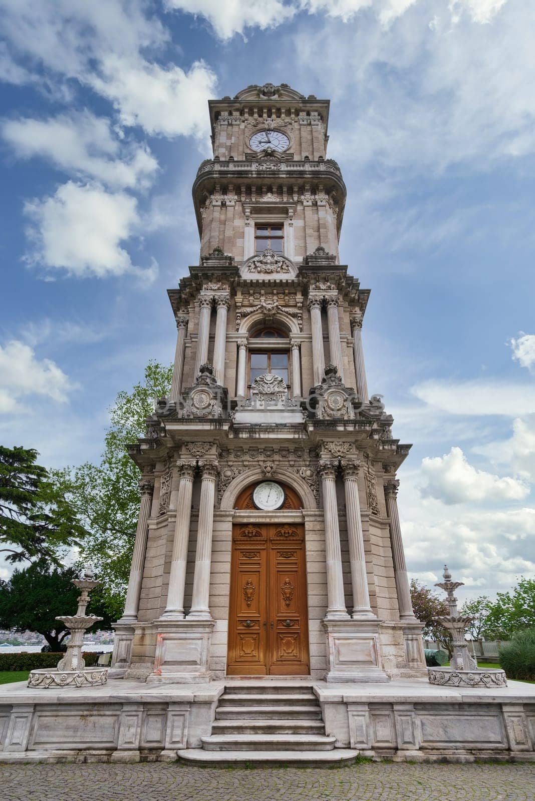 Day shot of Dolmabahce Clock Tower, Turkish: Dolmabahce Saat Kulesi, situated outside Dolmabahce Palace, Istanbul, Turkey, in a spring day
