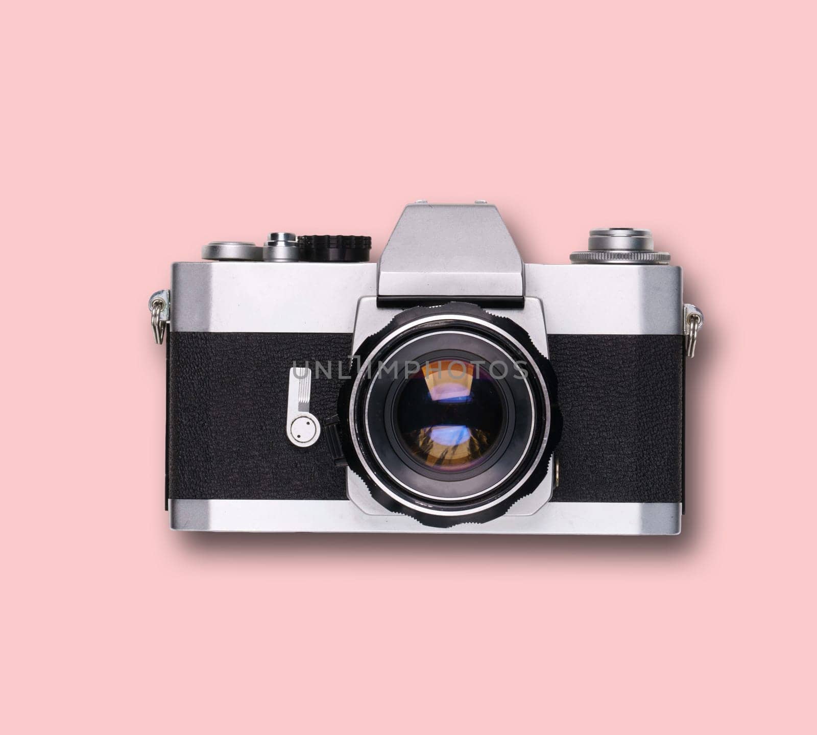 vintage old film camera on pink background with shadow