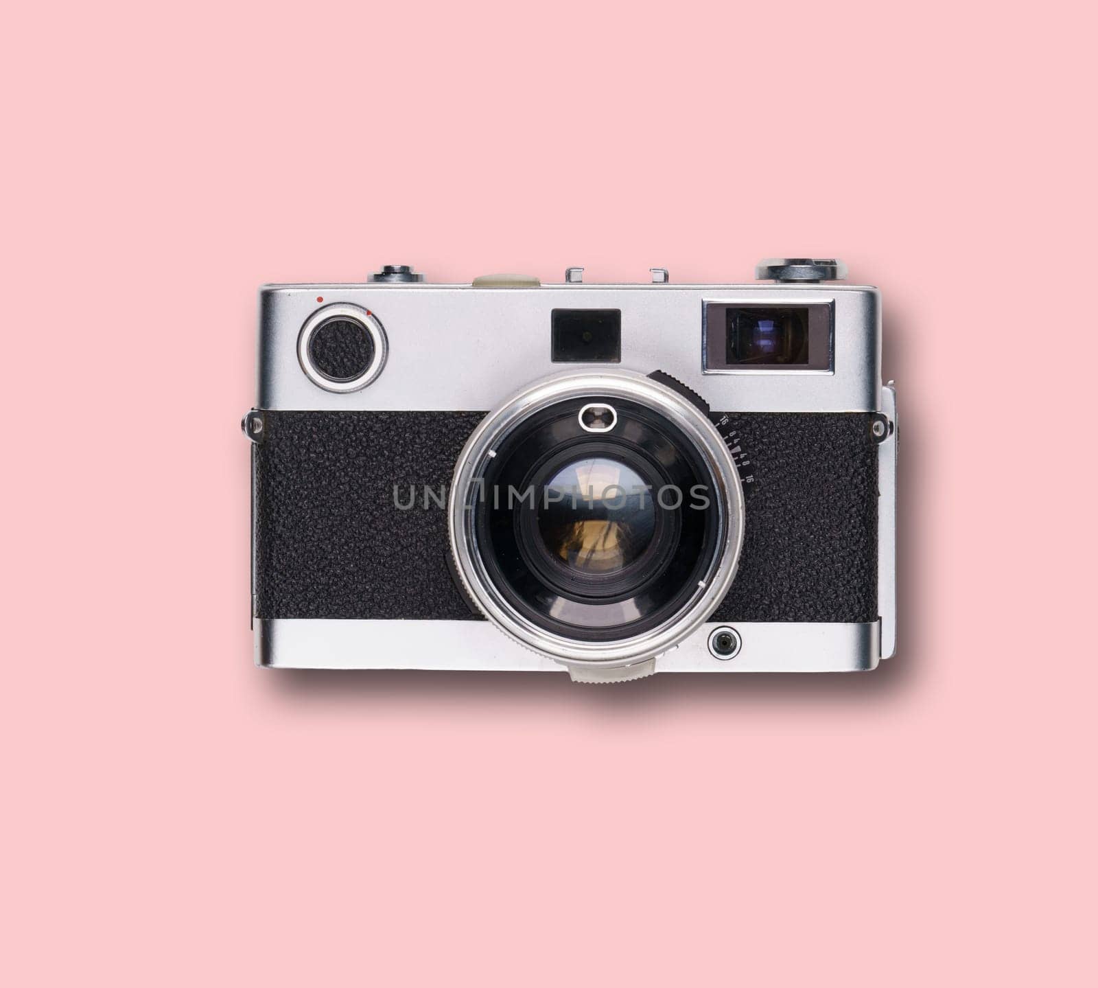 vintage old film camera on pink background with shadow