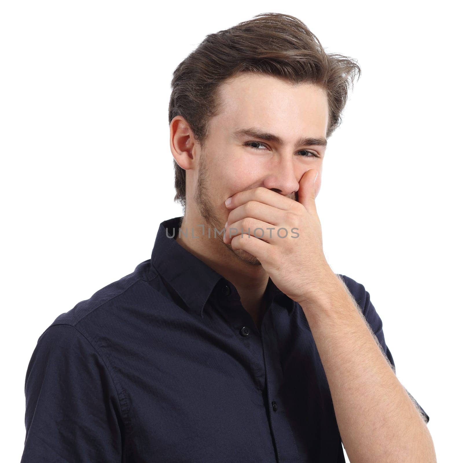 Handsome man laughing while covering his mouth with a hand isolated on a white background