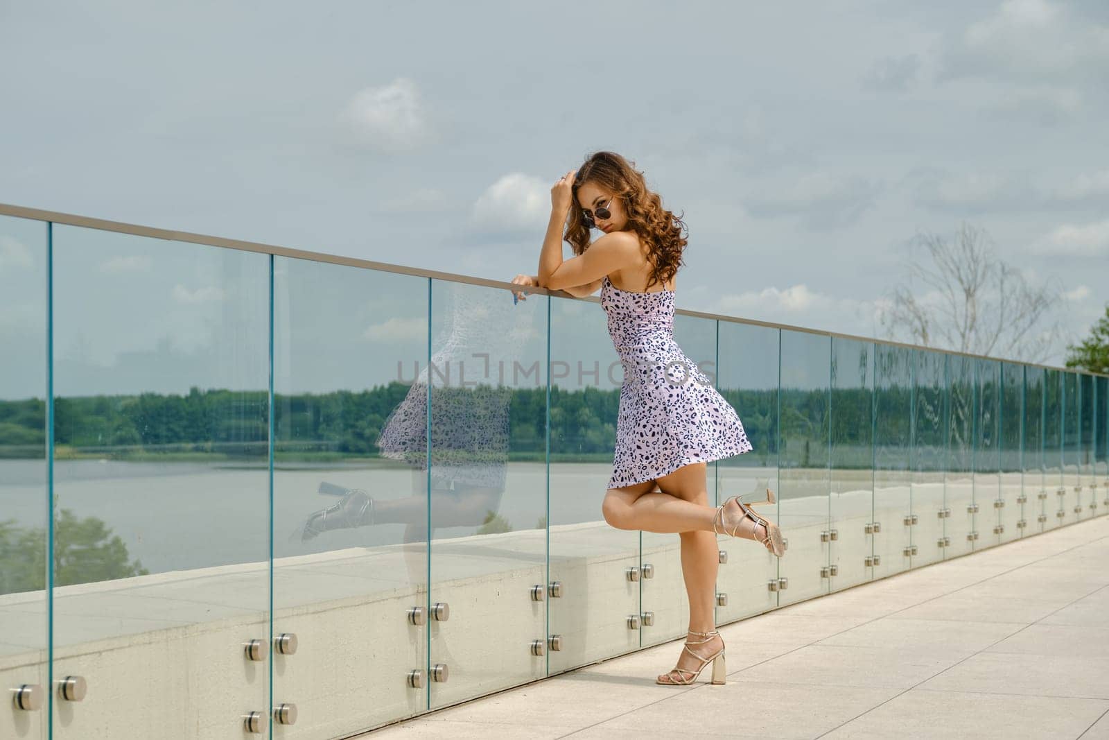 Joyful young woman standing on observation deck