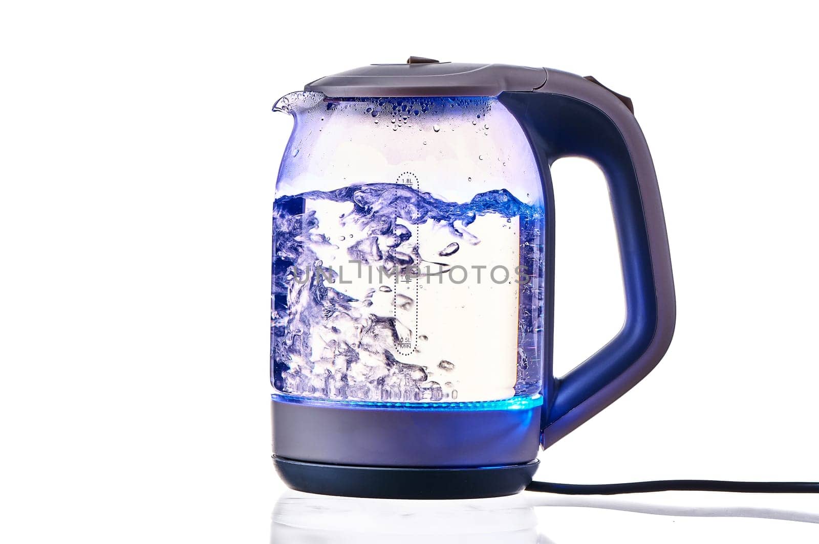 Glass electric kettle with boiling water on a white insulated background. High quality photo