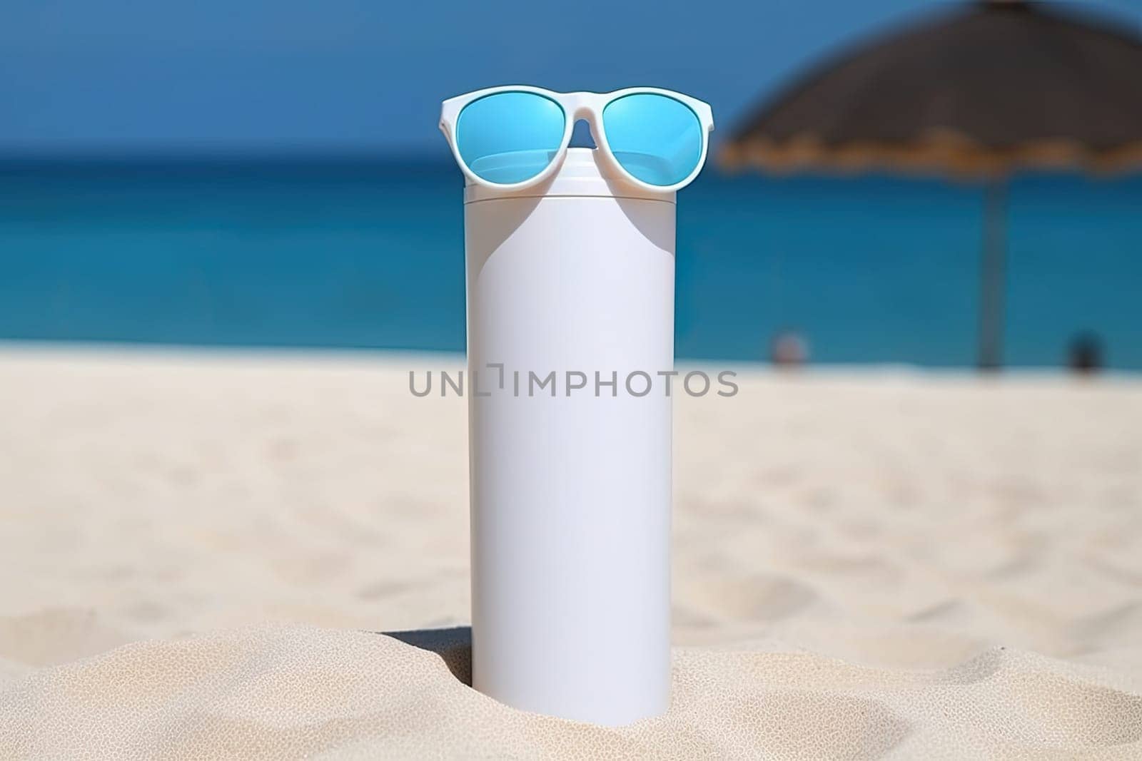 Sunscreen on sandy beach with sunglasses