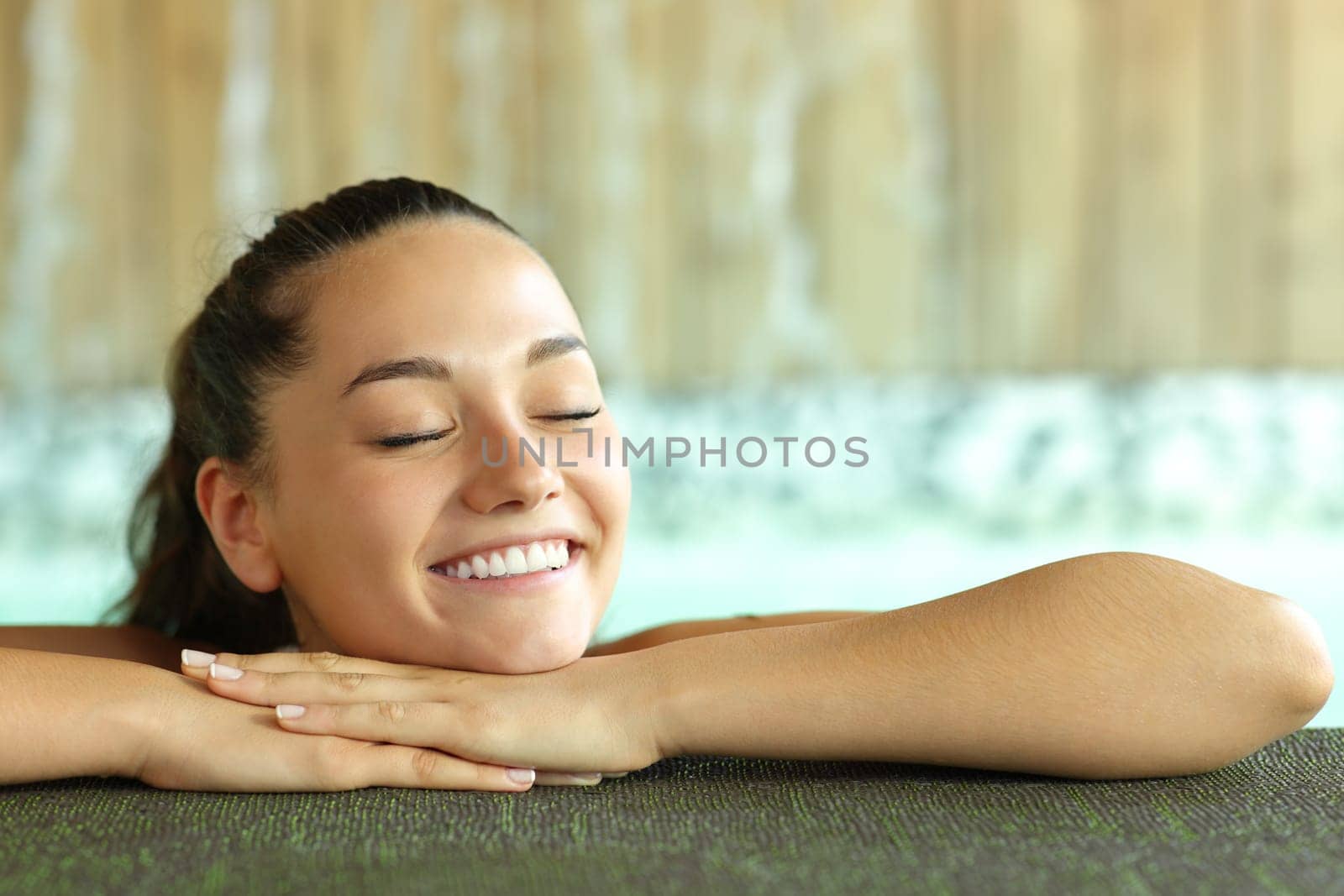 Happy woman smiling in spa pool