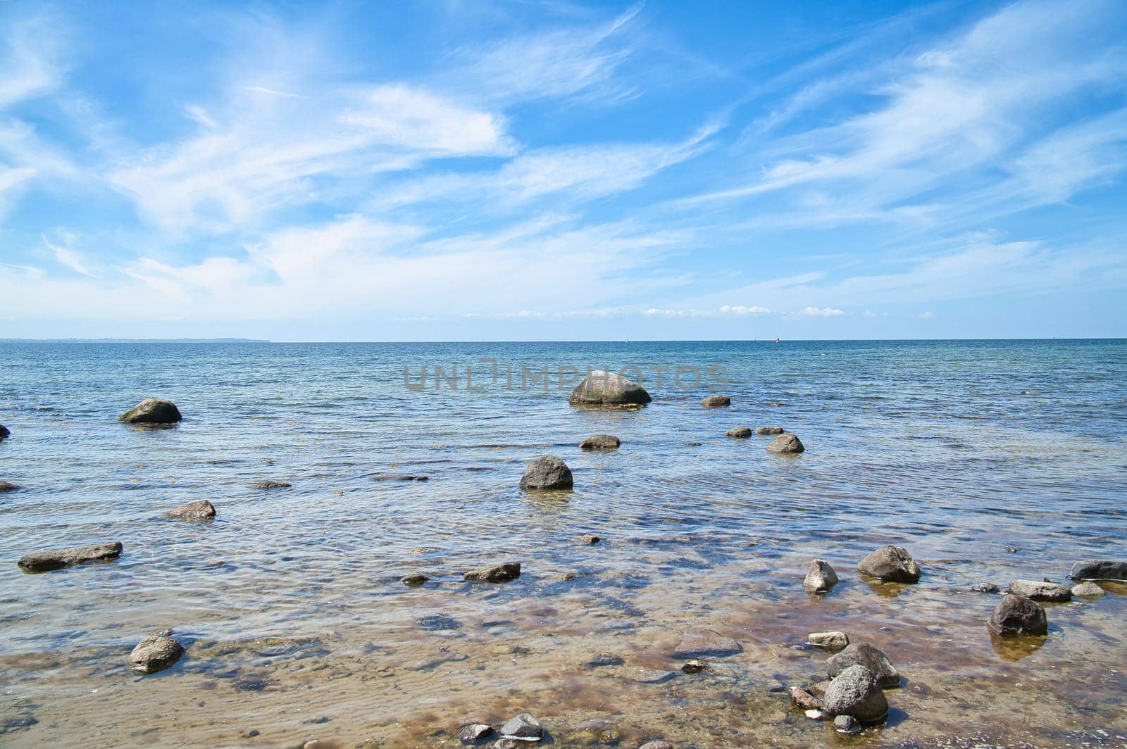 Stones and rocks on the Baltic coast in the sea. Landscape shot in sunshine. Nature from germany