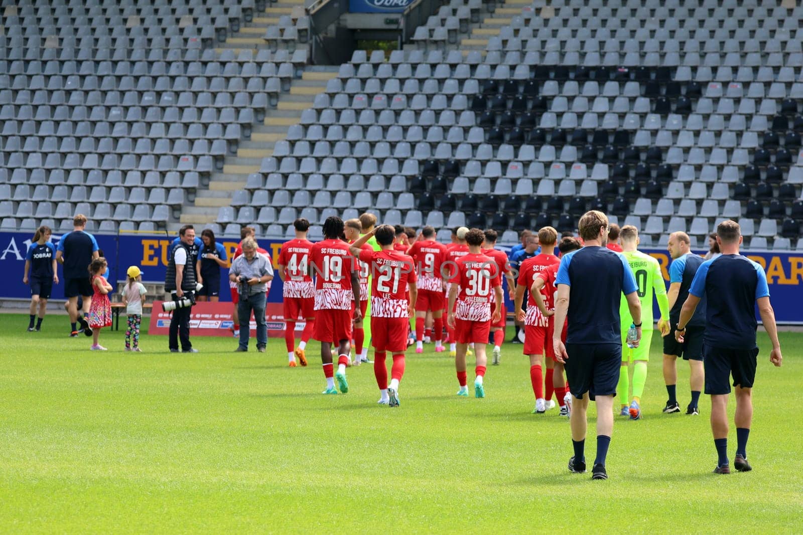Players and functional team of SC Freiburg II/U23 on their way to the team photo SC Freiburg II - U23 - Season 2023/24 -