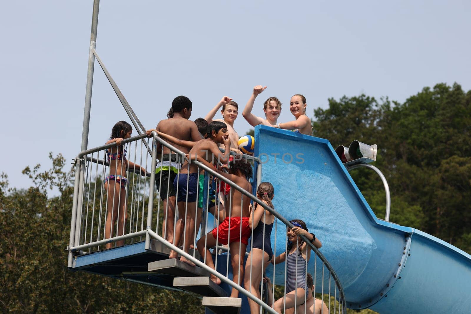 Theme picture summer -   The dog days are here - people crave to cool off at temperatures above 30 degrees Celsius,like here in the lido of Freiburg im Breisgau. The children have fun on the water slide and there is a lively crowd