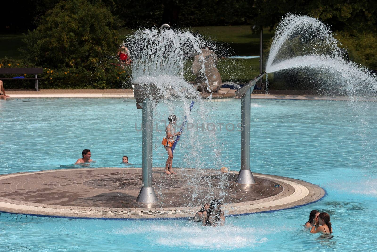 Theme picture summer -   The dog days are here - people crave to cool off at temperatures above 30 degrees Celsius,like here in the lido of Freiburg im Breisgau.