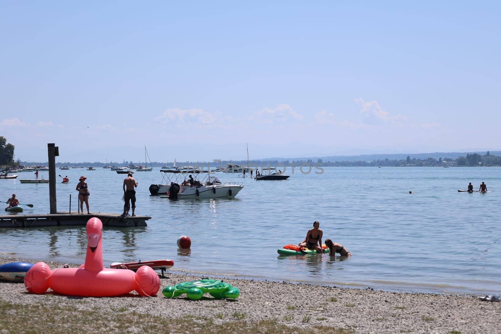 Theme picture Summer - Summer day at Lake Constance  Even at Lake Constance,as here near Allensbach,people were drawn to or to the water on this hot weekend. Young and old sought to cool off on a boat trip,an excursion with the Stand Up Paddle (SUP) or while swimming. The next few days are expected to remain hot in summer if thunderstorms are likely to occur