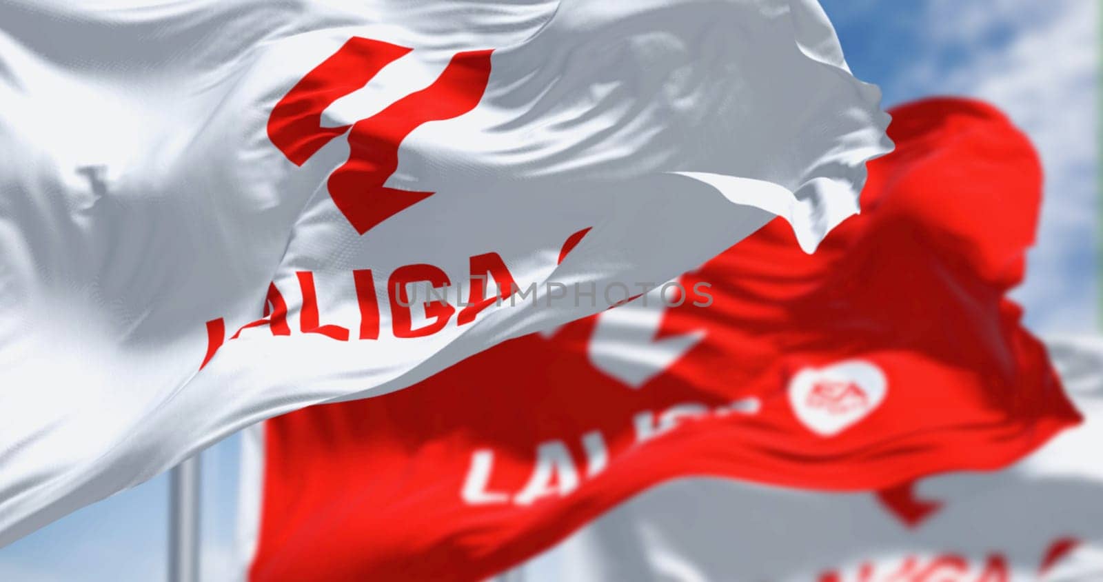 Madrid, SPA, July 5 2023: Three flags with La Liga logo waving in the wind. Top professional football division of the Spanish football league system. Illustrative editorial 3d illustration render