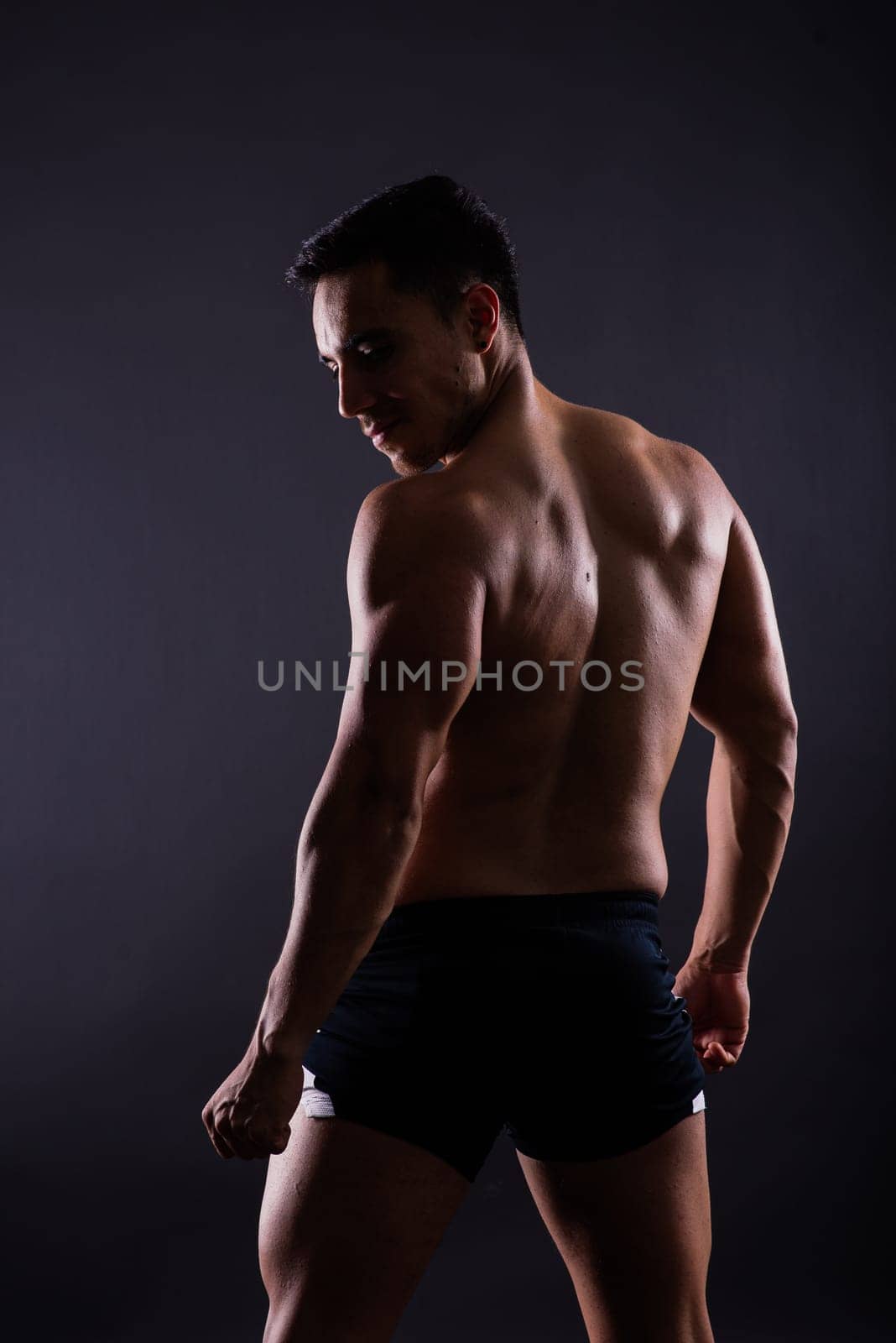 Muscular and torso of a young man having abs, bicep and chest. Male hunk with athletic body.