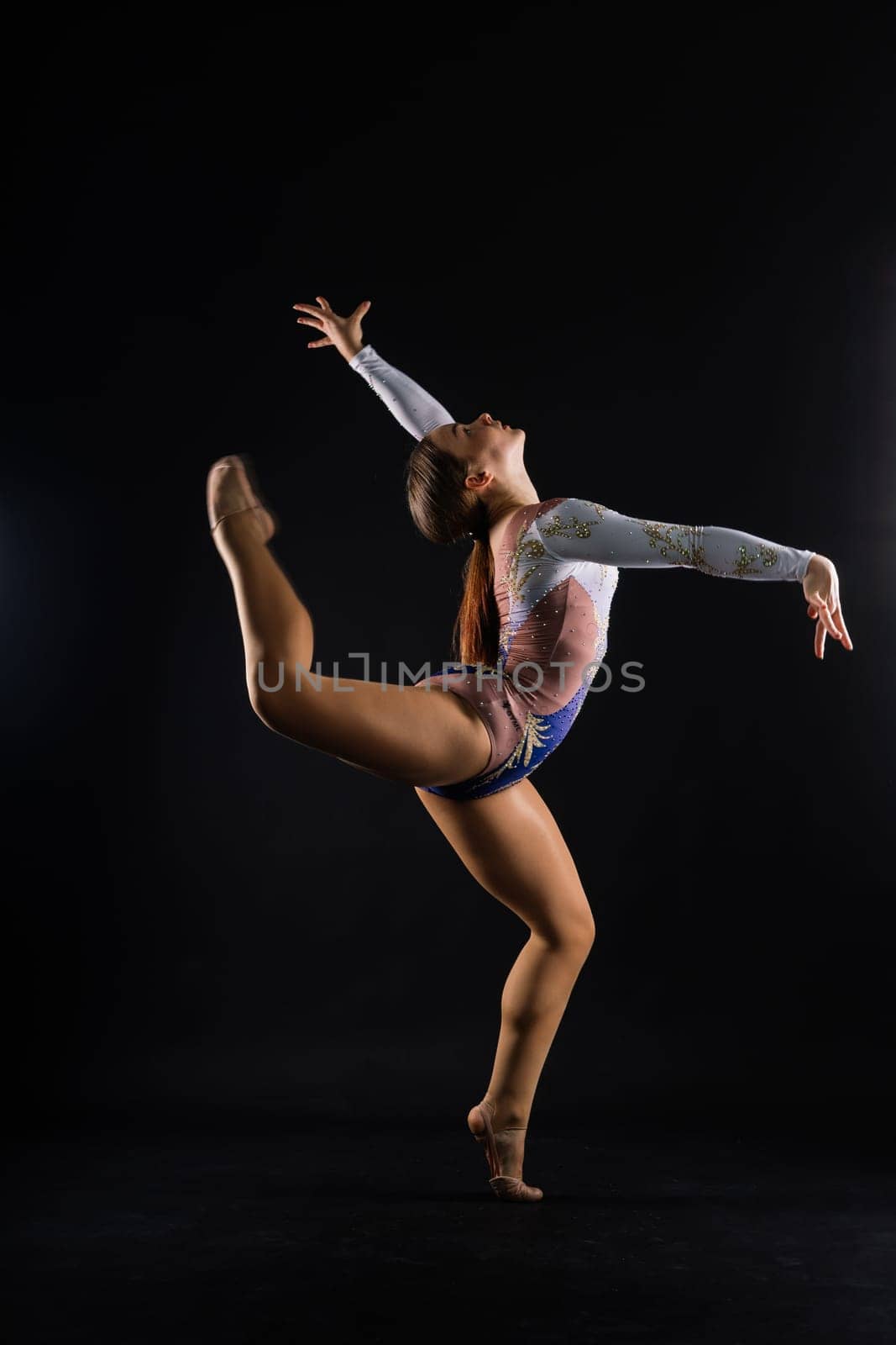 Fashion girl ballet dancer. Sport gymnastics studio shot on a white and black background